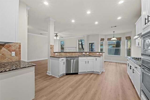 2509 Salorn Way, Round Rock, TX 78681 - kitchen featuring stainless steel appliances, decorative backsplash, white cabinets, light wood-style flooring, and recessed lighting