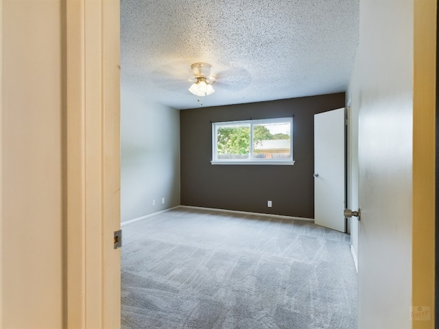 7920 Rockwood Ln Unit 115, Austin, TX 78757 - spare room featuring carpet, a textured ceiling, and ceiling fan