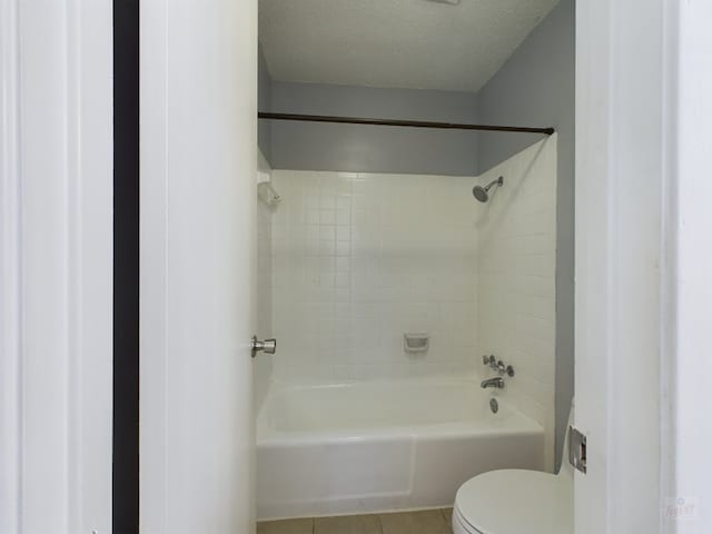 7920 Rockwood Ln Unit 115, Austin, TX 78757 - bathroom featuring tile patterned flooring, washtub / shower combination, and a textured ceiling