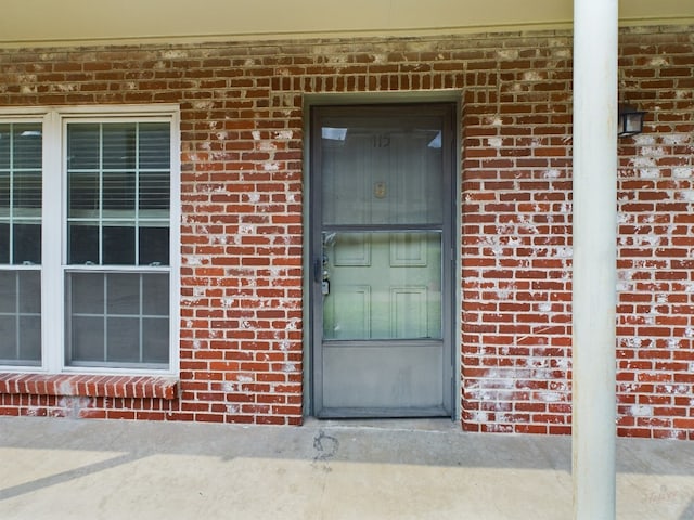 7920 Rockwood Ln Unit 115, Austin, TX 78757 - property entrance with brick siding and a porch