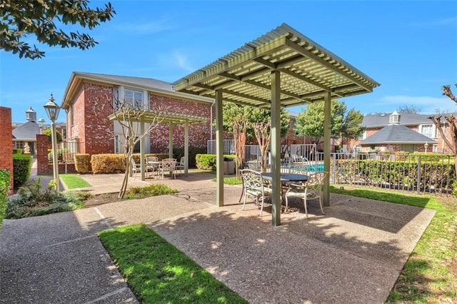 view of patio featuring a pergola and fence