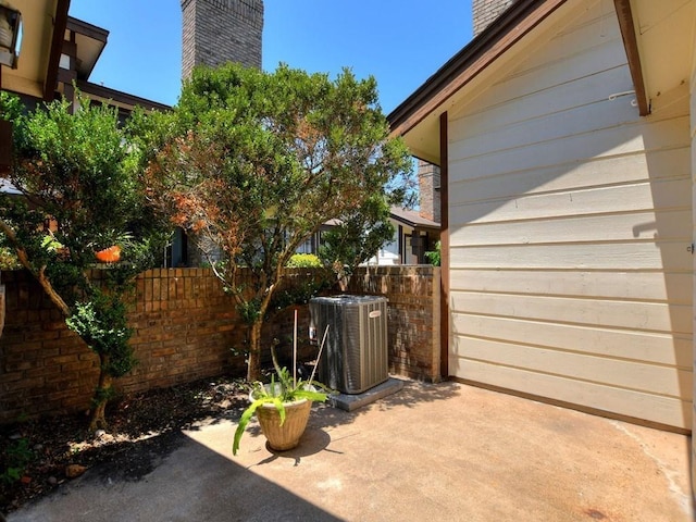 view of patio / terrace with central AC unit and fence