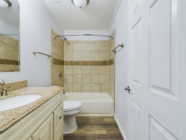bathroom with toilet, wood finished floors, crown molding, vanity, and shower / bathtub combination