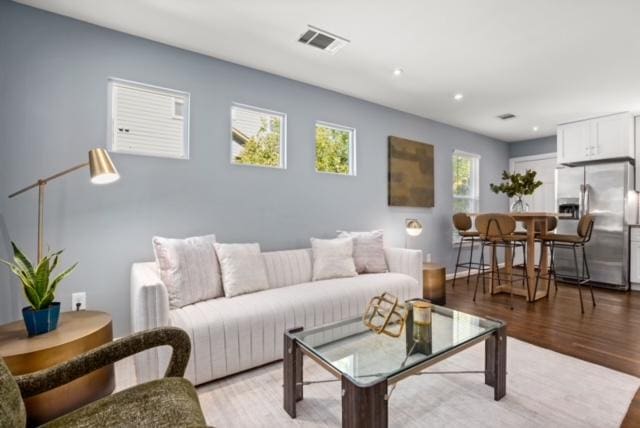 1183 Coleto St, Austin, TX 78702 - living room featuring light wood finished floors and recessed lighting
