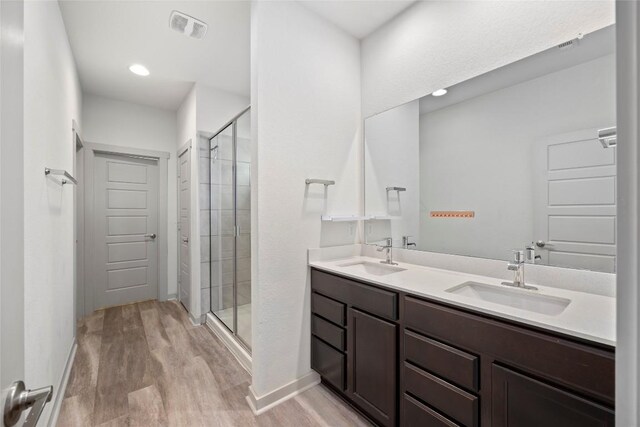 8220 Linnie Ln, Austin, TX 78724 - full bath featuring a stall shower, wood finished floors, double vanity, and baseboards