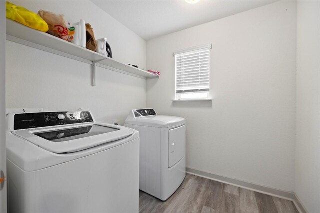 8220 Linnie Ln, Austin, TX 78724 - laundry area featuring independent washer and dryer, light wood-style floors, and baseboards