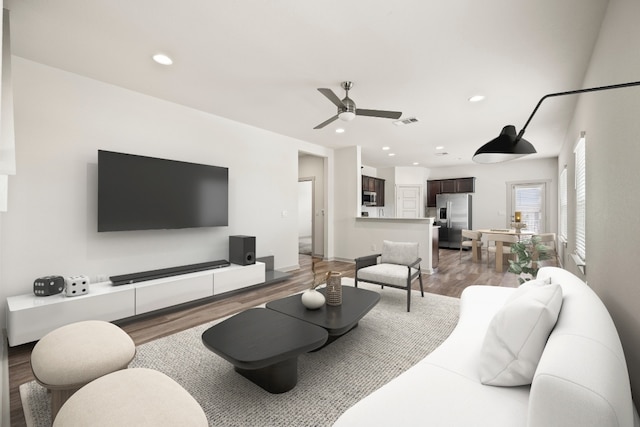 8220 Linnie Ln, Austin, TX 78724 - living room featuring light wood-style flooring, ceiling fan, and recessed lighting