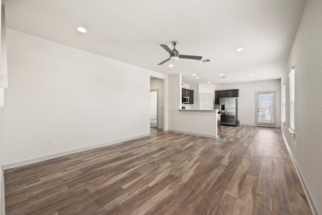 8220 Linnie Ln, Austin, TX 78724 - unfurnished living room with ceiling fan, dark wood-style flooring, baseboards, and recessed lighting