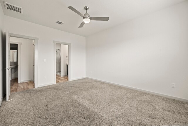 8220 Linnie Ln, Austin, TX 78724 - unfurnished bedroom featuring carpet flooring, baseboards, ceiling fan, and ensuite bathroom