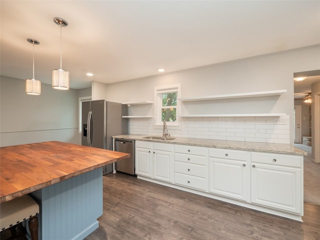 kitchen with open shelves, stainless steel dishwasher, a sink, wooden counters, and white cabinetry