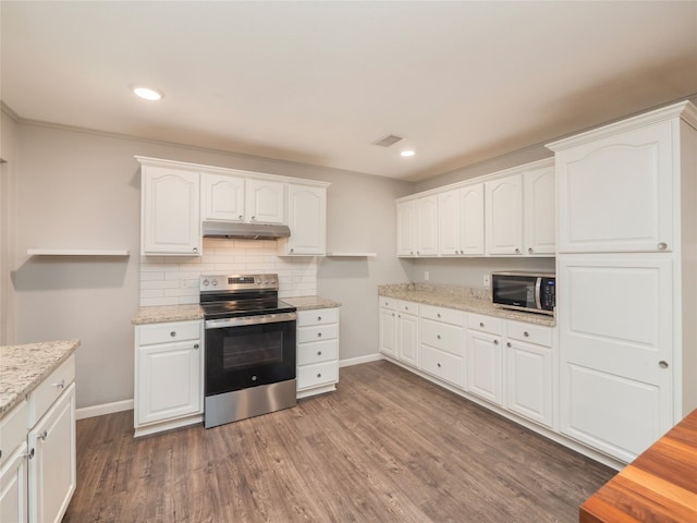 kitchen featuring stainless steel appliances, dark wood finished floors, white cabinetry, baseboards, and under cabinet range hood