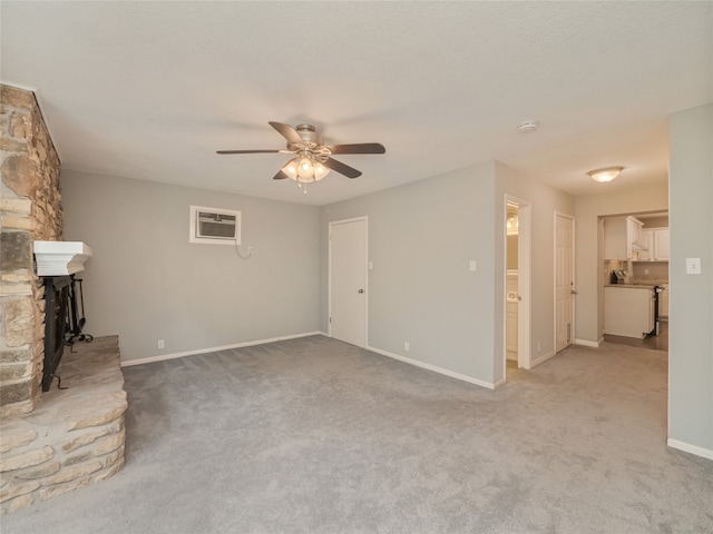unfurnished living room featuring ceiling fan, light carpet, baseboards, and a wall mounted AC