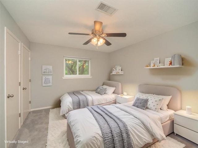 carpeted bedroom featuring ceiling fan, baseboards, and visible vents
