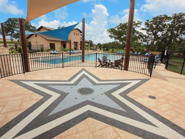 view of patio featuring fence and a community pool