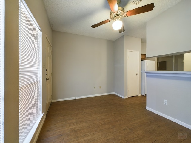 2901 San Jacinto Blvd Unit 105, Austin, TX 78705 - interior space featuring freestanding refrigerator, baseboards, ceiling fan, visible vents, and dark wood-style floors