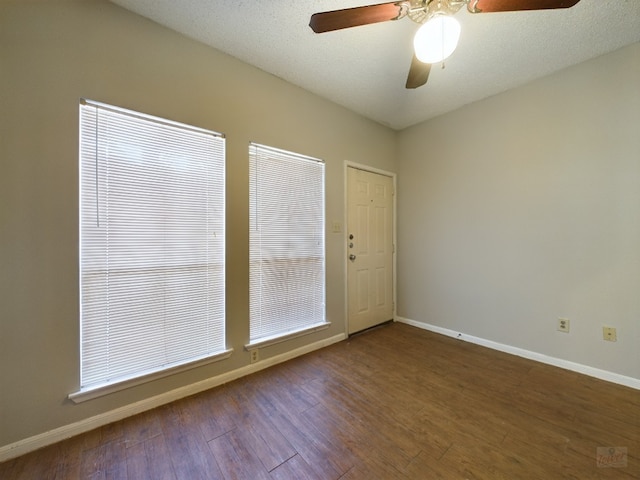 2901 San Jacinto Blvd Unit 105, Austin, TX 78705 - spare room featuring dark wood-type flooring, baseboards, and a ceiling fan