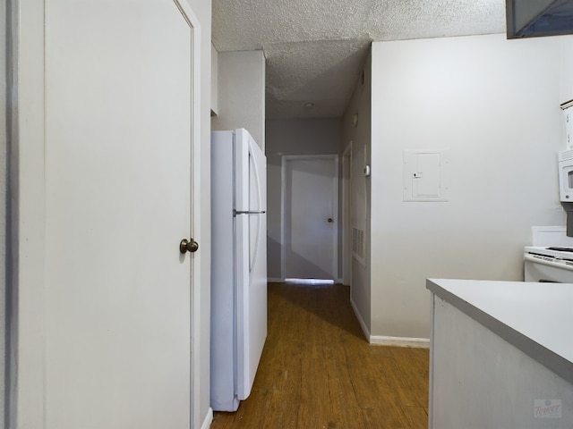 2901 San Jacinto Blvd Unit 105, Austin, TX 78705 - hallway featuring electric panel, a textured ceiling, dark wood-style flooring, and baseboards