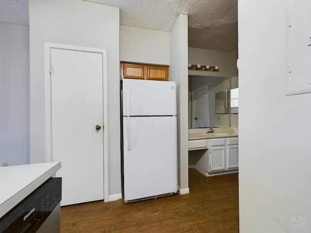 2901 San Jacinto Blvd Unit 105, Austin, TX 78705 - kitchen featuring freestanding refrigerator, a textured ceiling, light countertops, and dark wood-style floors