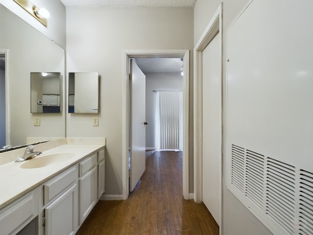 2901 San Jacinto Blvd Unit 105, Austin, TX 78705 - bathroom with vanity, baseboards, and wood finished floors