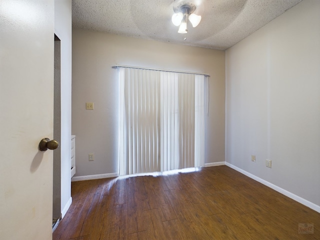 2901 San Jacinto Blvd Unit 105, Austin, TX 78705 - spare room featuring ceiling fan, a textured ceiling, baseboards, and wood finished floors