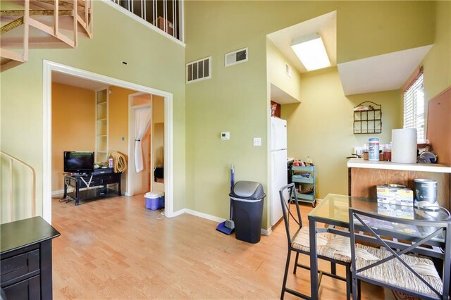 3115 Tom Green St Unit 404, Austin, TX 78705 - dining space with light wood finished floors, visible vents, and baseboards