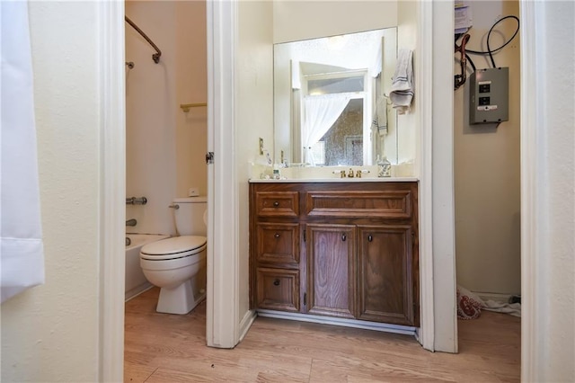 3115 Tom Green St Unit 404, Austin, TX 78705 - bathroom featuring toilet, tub / shower combination, wood finished floors, electric panel, and vanity