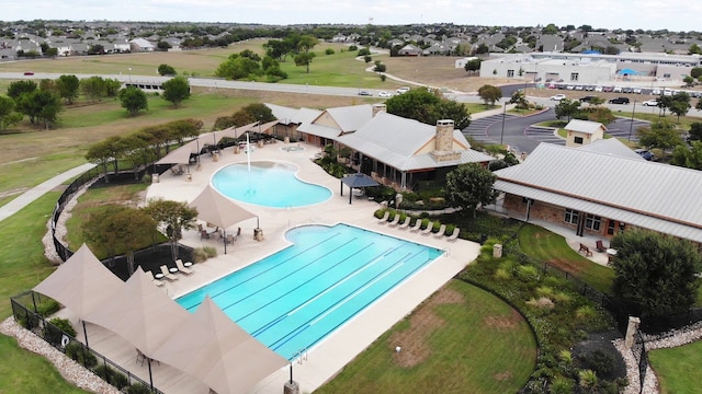 community pool with fence and a patio