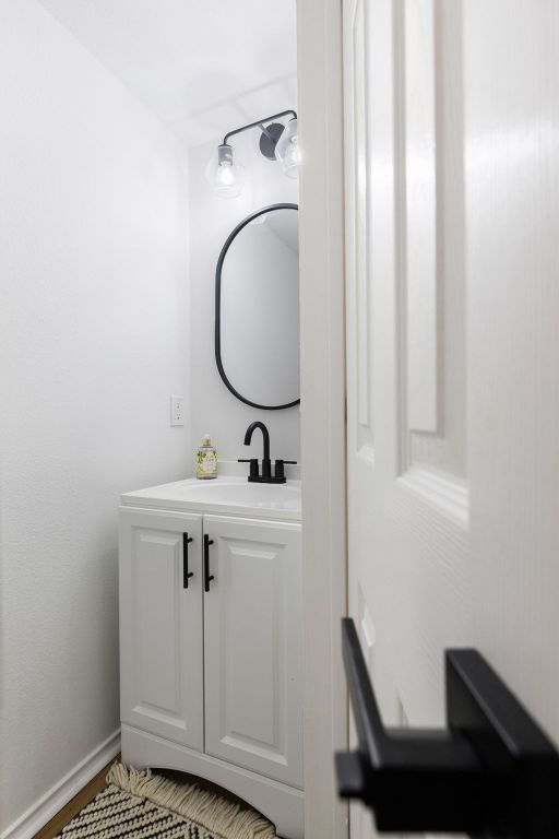 bathroom featuring baseboards and vanity