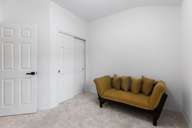living area with carpet, vaulted ceiling, and baseboards