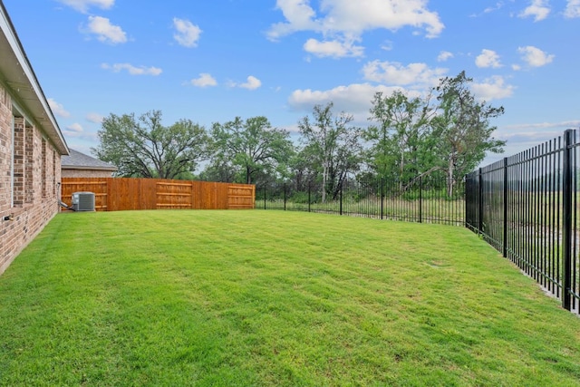 409 Rivers Edge Dr, Georgetown, TX 78628 - view of yard with a fenced backyard and central AC