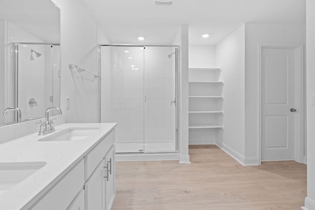 409 Rivers Edge Dr, Georgetown, TX 78628 - full bathroom featuring baseboards, wood finished floors, a stall shower, and a sink