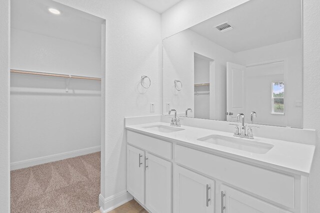409 Rivers Edge Dr, Georgetown, TX 78628 - full bath featuring double vanity, visible vents, a spacious closet, and a sink