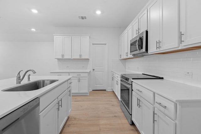 409 Rivers Edge Dr, Georgetown, TX 78628 - kitchen with recessed lighting, light countertops, stainless steel appliances, and a sink