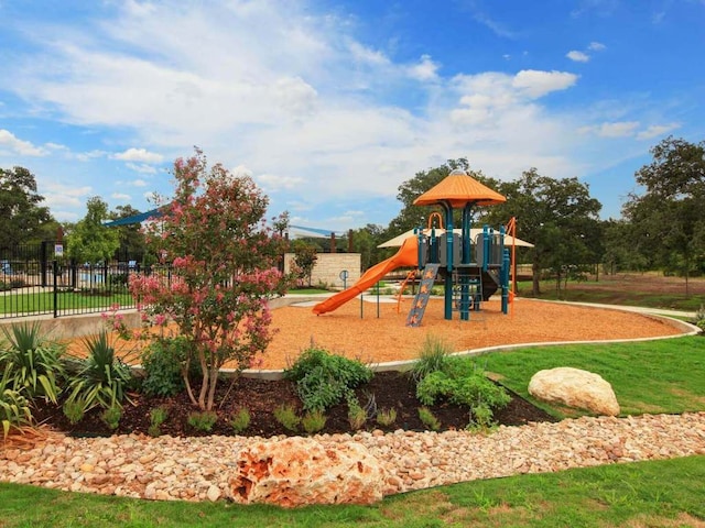 community jungle gym featuring fence