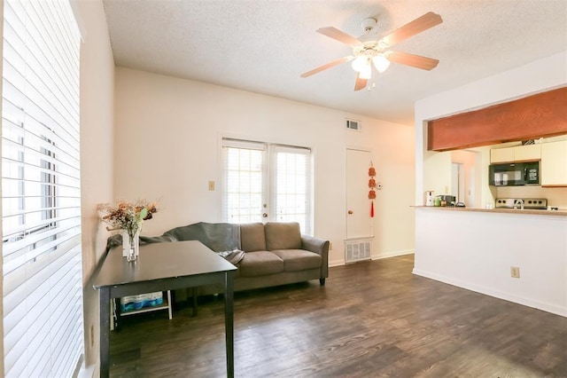 912 W 22nd St Unit 307, Austin, TX 78705 - living area featuring dark wood-style floors, a ceiling fan, a textured ceiling, and baseboards