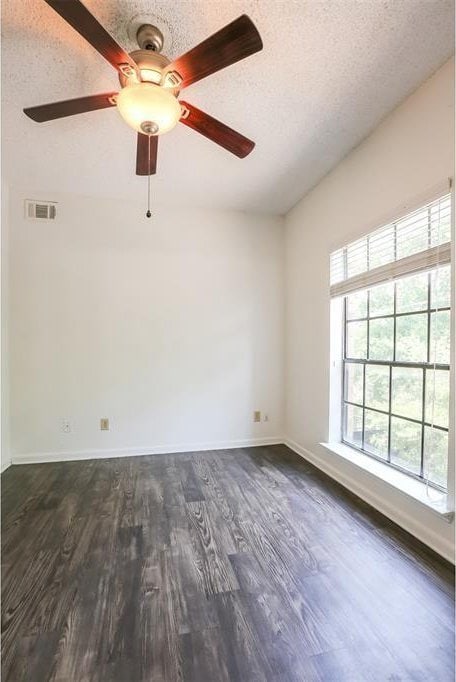 912 W 22nd St Unit 307, Austin, TX 78705 - spare room with a textured ceiling, dark wood-style flooring, ceiling fan, and baseboards