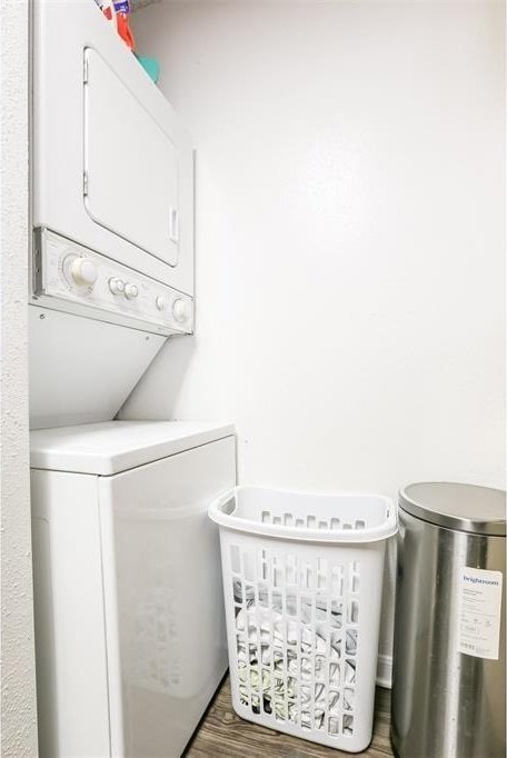 912 W 22nd St Unit 307, Austin, TX 78705 - washroom with stacked washer / dryer and wood finished floors