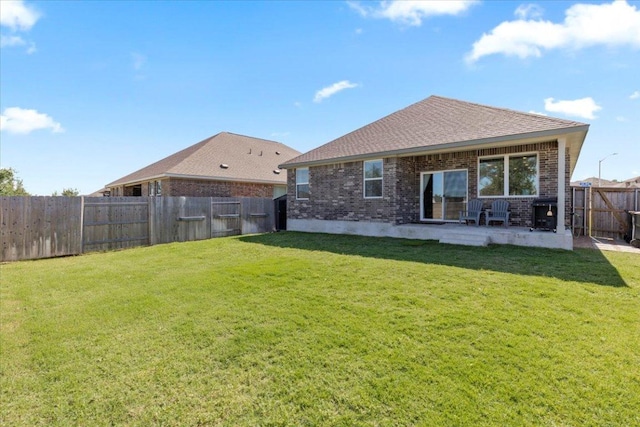 1001 Dog Iron St, Georgetown, TX 78633 - back of house featuring a yard, a patio area, and brick siding