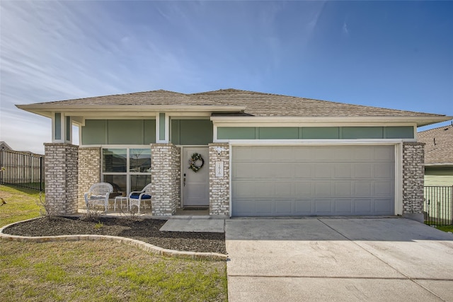 prairie-style house with concrete driveway, stucco siding, a garage, and fence