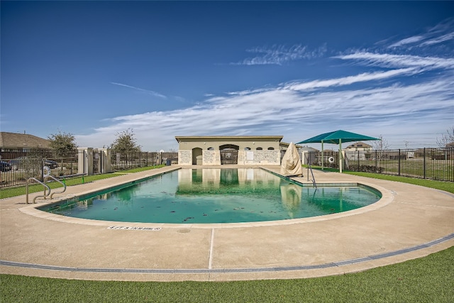 pool with fence and a patio
