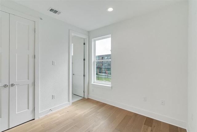 unfurnished bedroom with visible vents, light wood-style flooring, baseboards, and recessed lighting