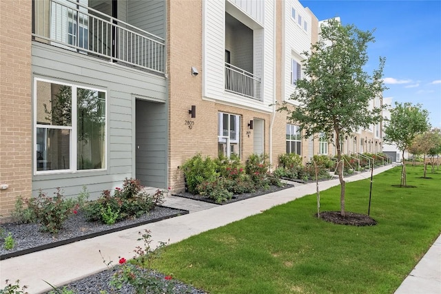 view of home's community with a lawn