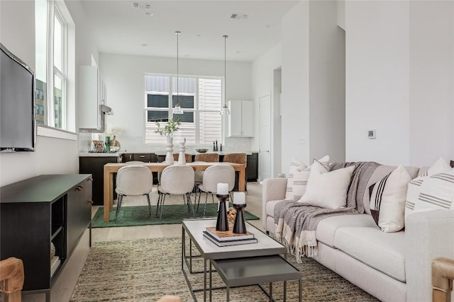 living room featuring a towering ceiling