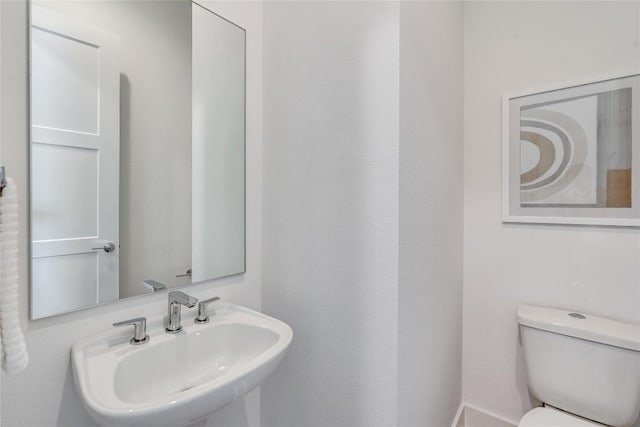 bathroom with toilet and a sink