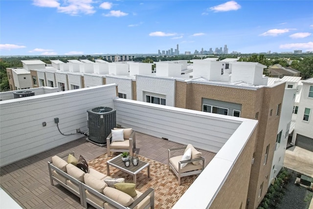 view of patio featuring a city view, outdoor lounge area, central AC unit, and a balcony