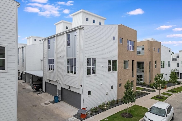 exterior space featuring concrete driveway and an attached garage