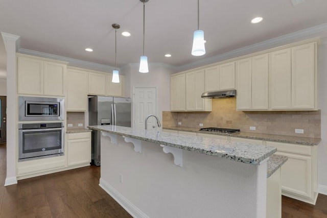 kitchen featuring under cabinet range hood, crown molding, appliances with stainless steel finishes, and backsplash