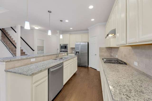 kitchen with stainless steel appliances, a sink, wall chimney exhaust hood, dark wood-style floors, and decorative backsplash