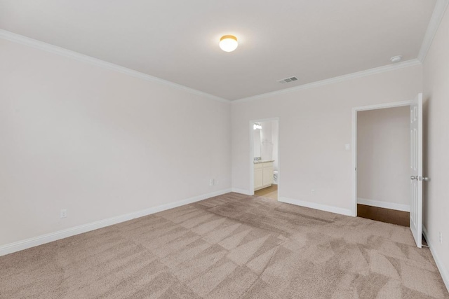 unfurnished bedroom featuring baseboards, visible vents, crown molding, and light colored carpet