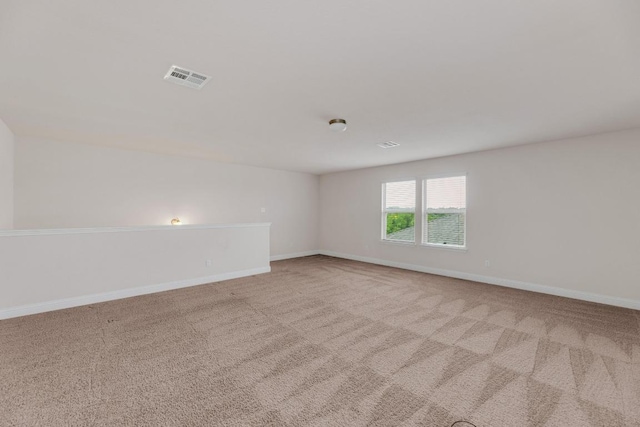 carpeted empty room with baseboards and visible vents